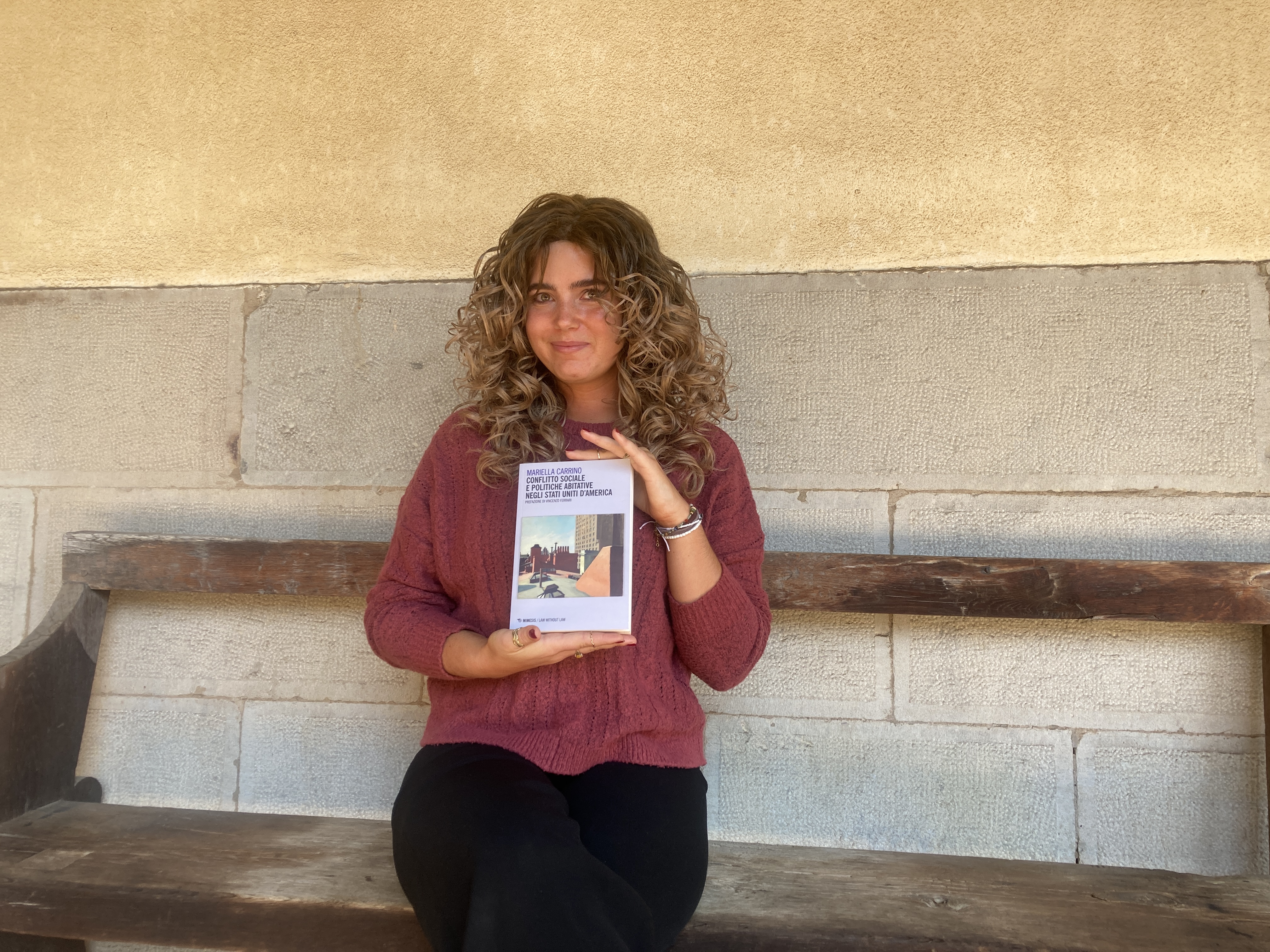 Hannah Atzwanger poses with Mariella Carrino's book.